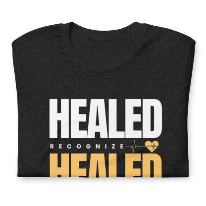 Black t-shirt with 'HEALED' text design on a white background