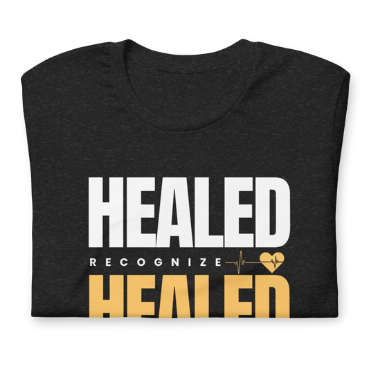 Black t-shirt with 'HEALED' text design on a white background